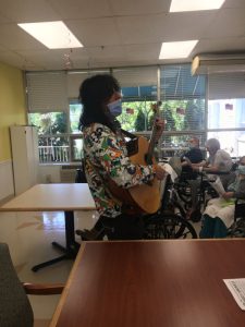 IMG-0232_scaled Person playing guitar and singing