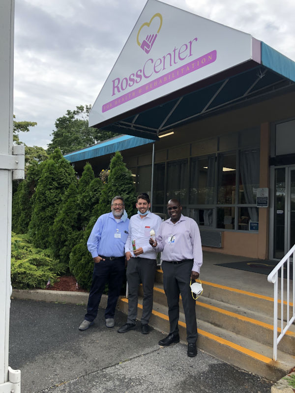 Employees in front of Ross Center holding ice creams